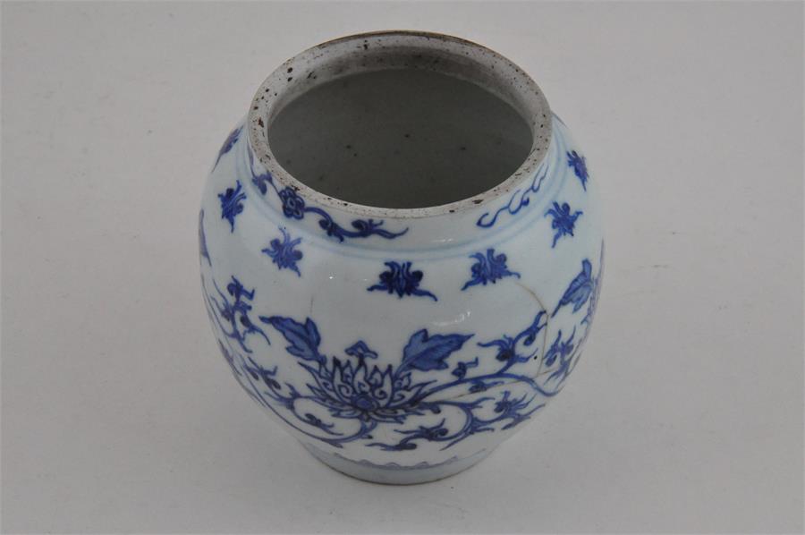 A Chinese transitional style vase with Lotus decoration, possibly of the period.At fault. 11cms high