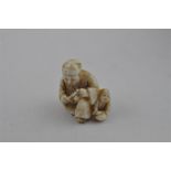 A Japanese Meiji period carved ivory netsuke, of parent and child, signed, height 2.7 cm.