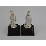 Two South East Asian carved ivory figures, early 20th century, both adorned in robes and holding a