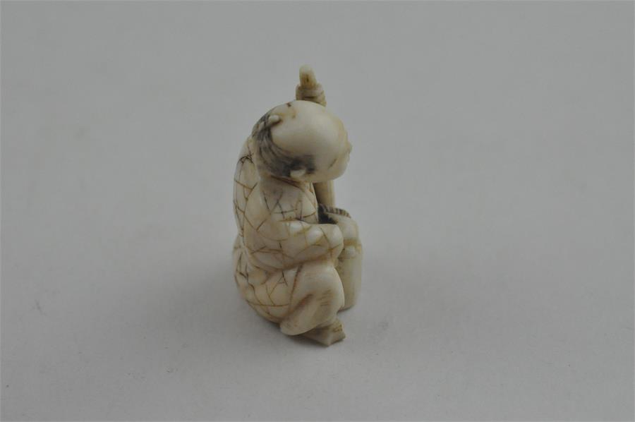 A Japanese late Meiji period carved ivory small okimono, of a man seated by log with a brush. Height - Image 4 of 5