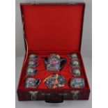 An early mid 20th century Chinese red landscape box cased 15 piece tea set of millifleur blue ground