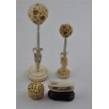 A Chinese ivory collection of ivory including two puzzle balls on stands. a carved ivory musell