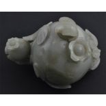 A Chinese jade water pot and stopper, probably 19th century, carved as a pomegranate on a sprig