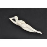 A Chinese carved ivory medicine doll, late 19th century, fashioned as a naked woman with one hand to