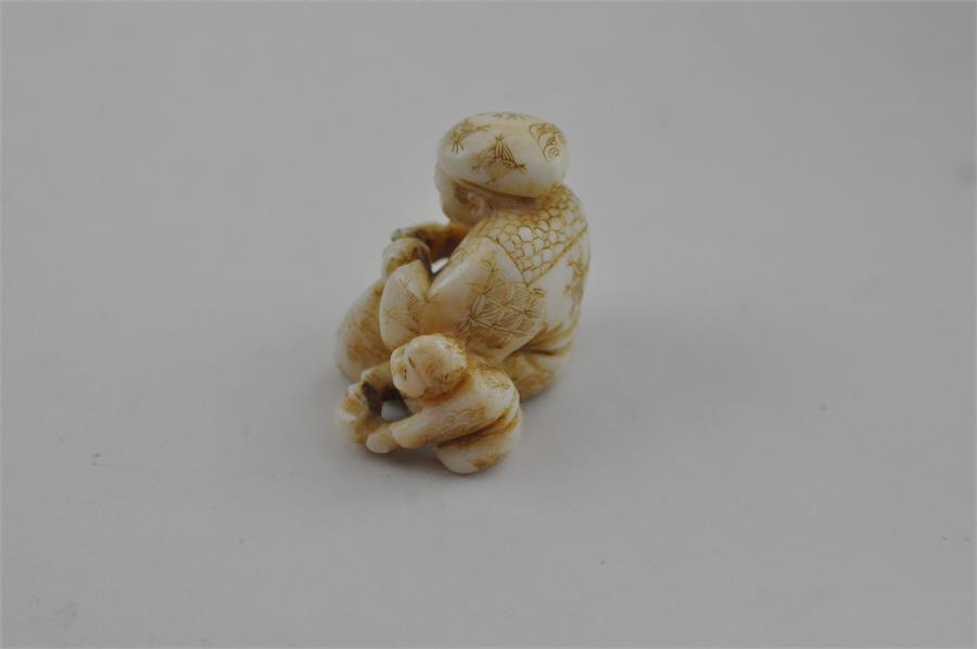 A Japanese Meiji period carved ivory netsuke, of parent and child, signed, height 2.7 cm. - Image 2 of 6