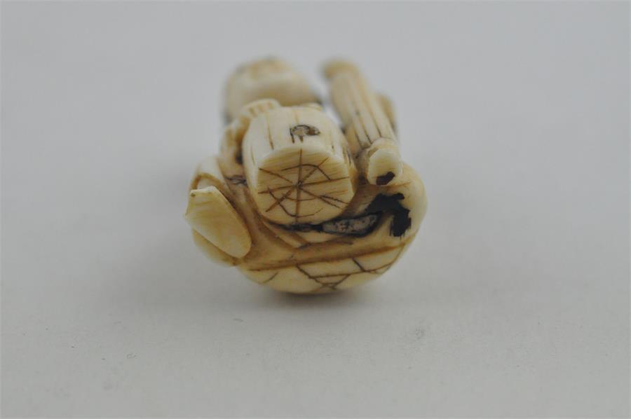 A Japanese late Meiji period carved ivory small okimono, of a man seated by log with a brush. Height - Image 5 of 5