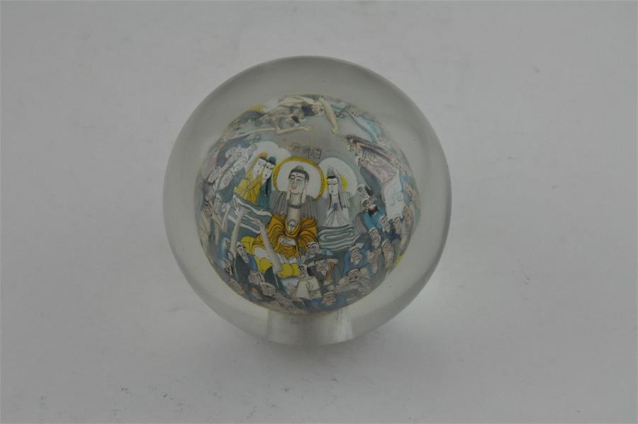 A Chinese reverse painted glass paperweight, early 20th century, of spherical form, interior reverse