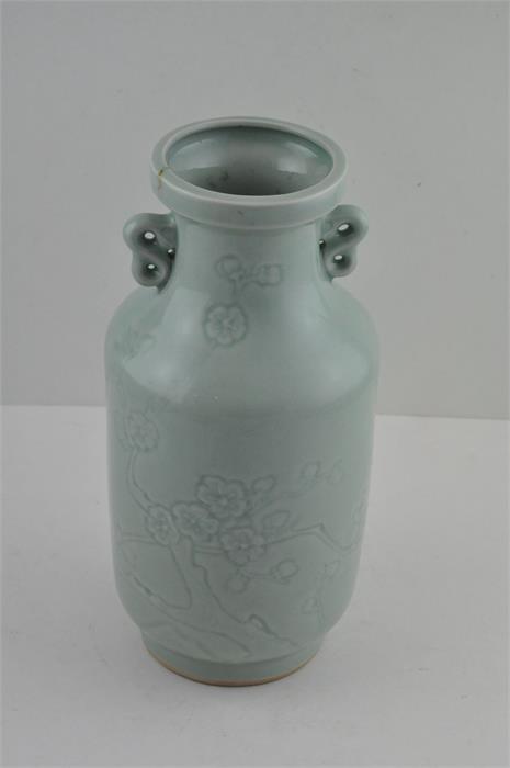 A Chinese celadon vase, republic period, having twin handles with impressed prunus blossom