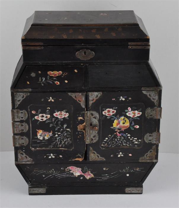 A Chinese black lacquered and mother of pearl inlaid table top cabinet, having painted mother of