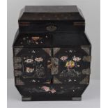 A Chinese black lacquered and mother of pearl inlaid table top cabinet, having painted mother of