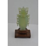 A Chinese jade vase, 20th century, in the archaic style, having triple pairs of pierced and carved