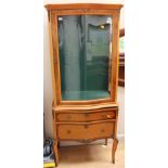 A French style kingwood veneered vitrine, fitted with a single glazed door and two drawers,