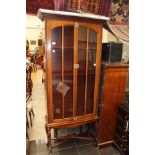 An early 20th Century mahogany bookcase, the two glazed doors enclosing fitted shelves,