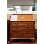 A George III style mahogany bureau, the fall front opening to reveal a fitted interior,
