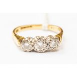 A diamond three stone 18ct gold ring,