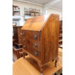 A Regency style mahogany double pedestal dining table and a set of eight bar back chairs with brass