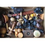 A collection of treen including turned ebony candlesticks, boxes, napkin rings,