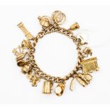 A 9ct charm bracelet with eighteen charms,