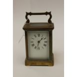 A brass carriage clock, with key,