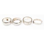 Four silver bangles, engraved decoration,
