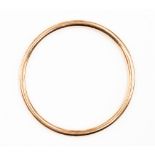 A 9ct rose gold slave bangle, round hollow section, internal diameter approx 68mm,
