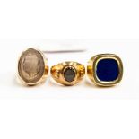 A group of three 14ct gold signet ring, one set with a cushion shaped Lapzig Lazuli, size W,