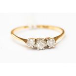 An 18ct gold and diamond three-stone ring, L, total gross weight 1.