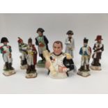 A Staffordshire figure of Napoleon; together with two further Napoleon figures and a bust,