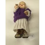 An unusual, early 20th Century walking doll, tin body and legs, complete with key, fingers a/f,