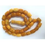 An Amber type necklace comprising ovoid shaped beads all of a similar size approx 15mm long,