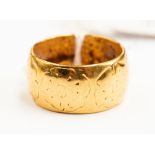 A 22ct gold patterned wedding band, engraved flower pattern, size O, weight approx 11.