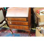 An early 20th Century walnut veneered bureau, the fall front enclosing a fitted interior,