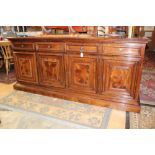 A contemporary mahogany sideboard, fitted with four drawers over four cupboard doors,