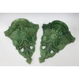 A pair of ceramic green man wall pockets.