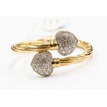 A 9ct gold cz set stylised snake bangle, with two diamond set heart details, total gross weight 14.