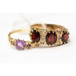 A garnet three stone 9ct gold dress ring, size R, together with an amethyst 9ct gold dress ring,