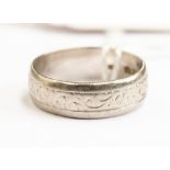 A platinum wedding band, with embossed scroll design, size Q,