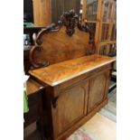 A Victorian mahogany chiffonier, carved back, the base with a single frieze drawer, two doors below,