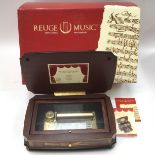 A boxed Reuge music, table top cylinder music box,