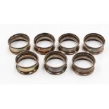 A set of seven silver napkin rings, six Birmingham 1926, one Sheffield 1918,