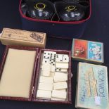 Four Thomas Taylor bowling balls, with assorted dominoes,