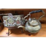 An Islamic copper swing handled cauldron, having applied brass decoration, along with a kettle.