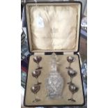 A cased glass decanter with six silver liqueur glasses, dated 1924, Birmingham,