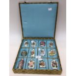 Twelve contemporary Chinese ceramic snuff bottles in display box