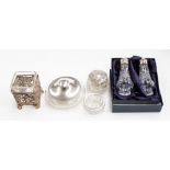 A cased salt and pepper pot with silver tops,