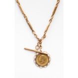 A 1912 half sovereign encased in fancy scroll mount, on a fancy link chain probably 9ct gold chain,