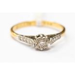 A diamond solitaire ring set in 18ct gold (stamped) and platinum, illusion set, size N1/2,