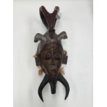 A West African tribal carved wood mask.