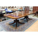 A George III style twin pedestal extending dining table, with two removable leaves, 76cm high,