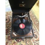 A vintage circa 1930s record player, HMV wind up, black cased, portable with Max Bygraves record,